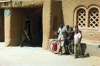 in front of clay-made houses in Agadez